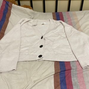 A light-pink coloured cardigan